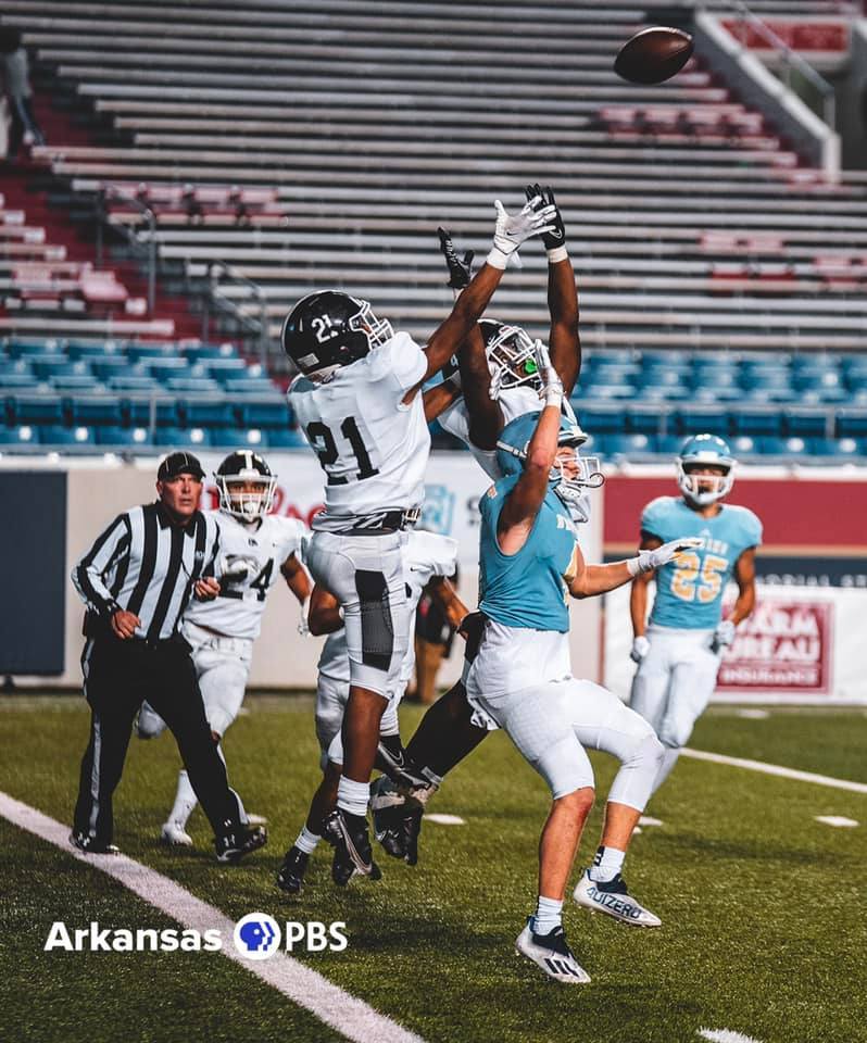 An official watches a contested pass during a Northwest Arkansas high school football game