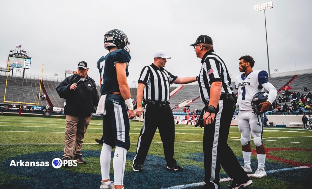 NWAFOA officials conduct the pregame coin toss with team captains